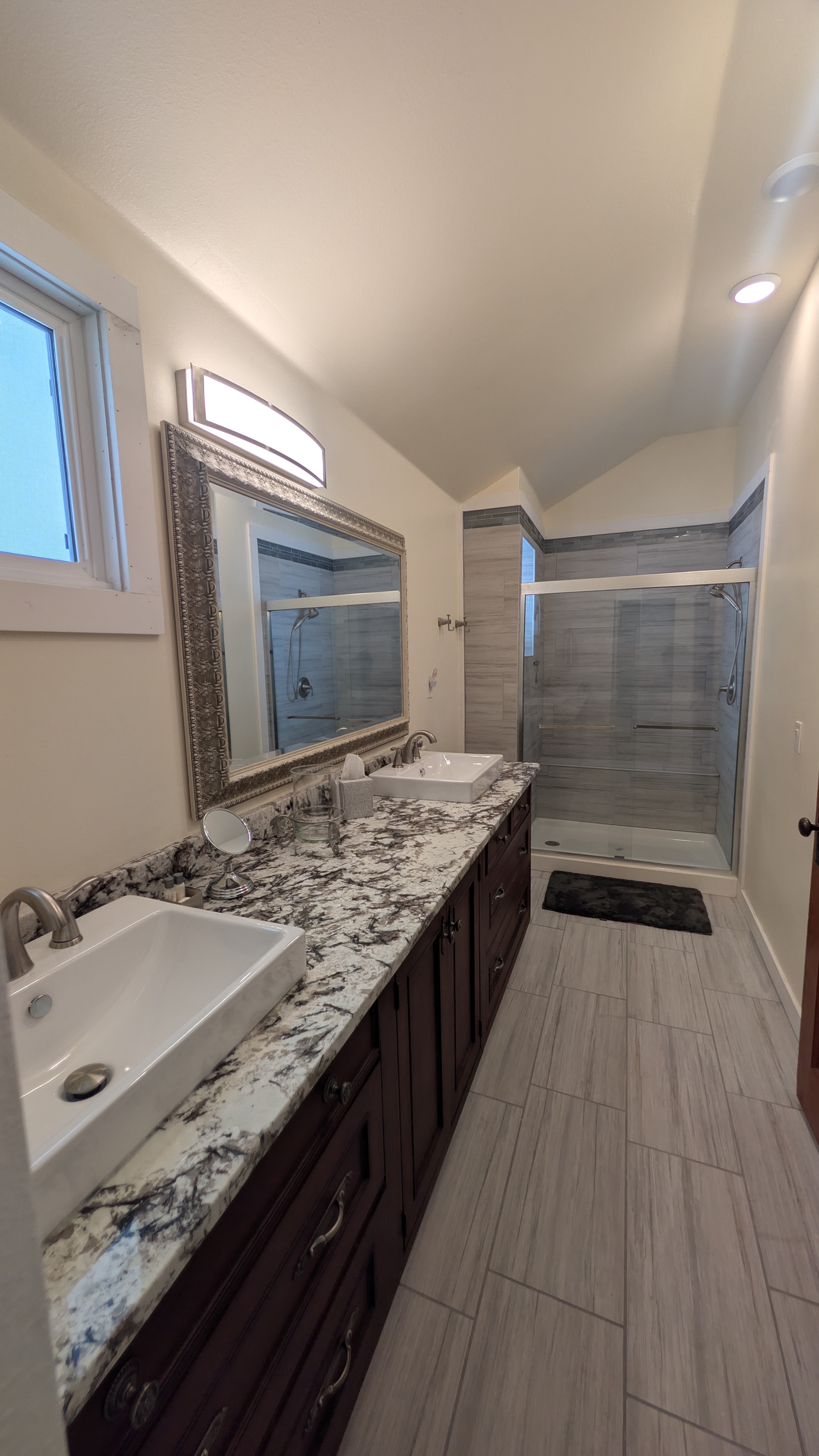 Master bathroom with dual granite vanity and walk-in shower