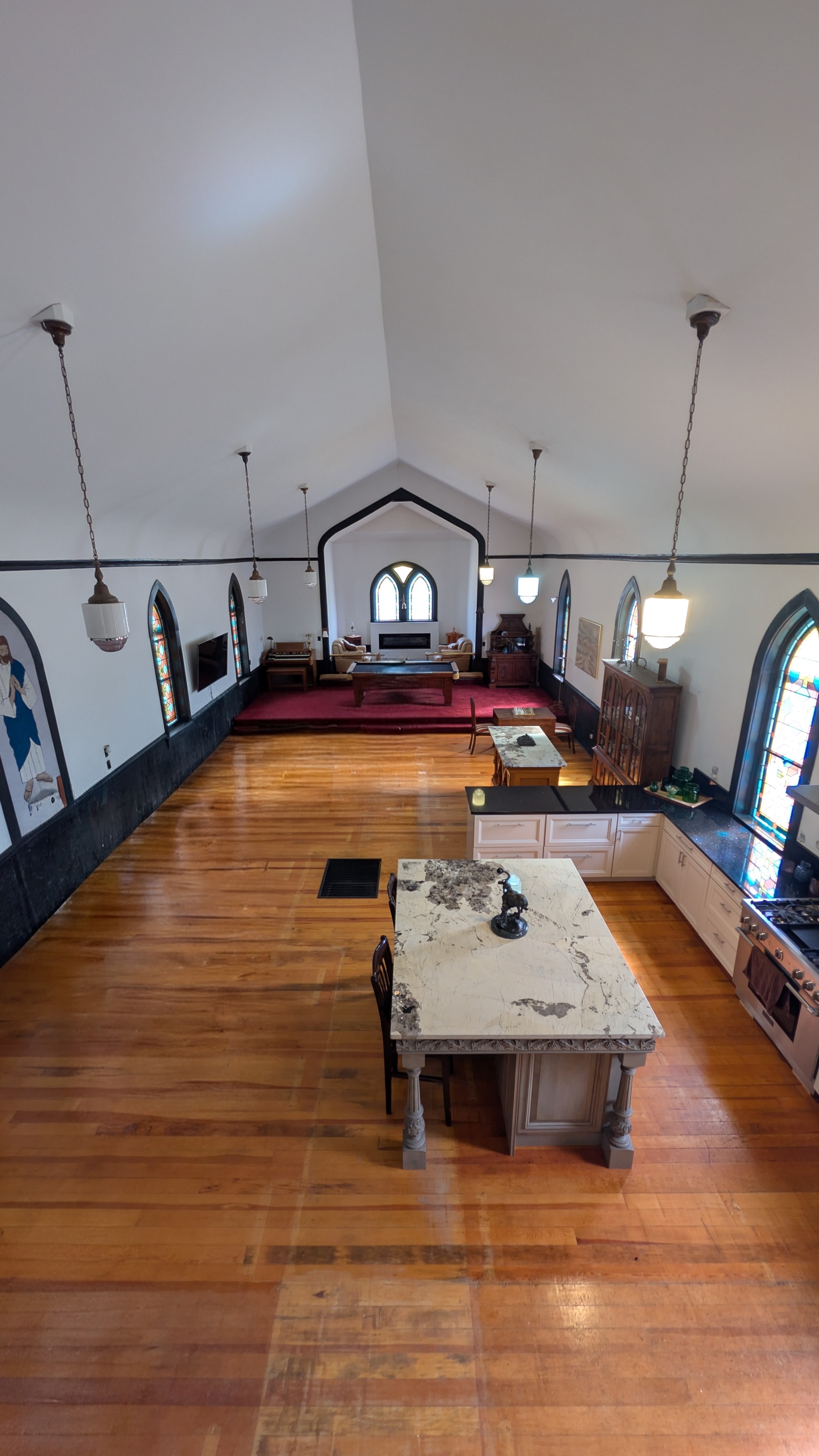 Gathering space in the Old Red Chapel with vaulted ceilings and stained glass