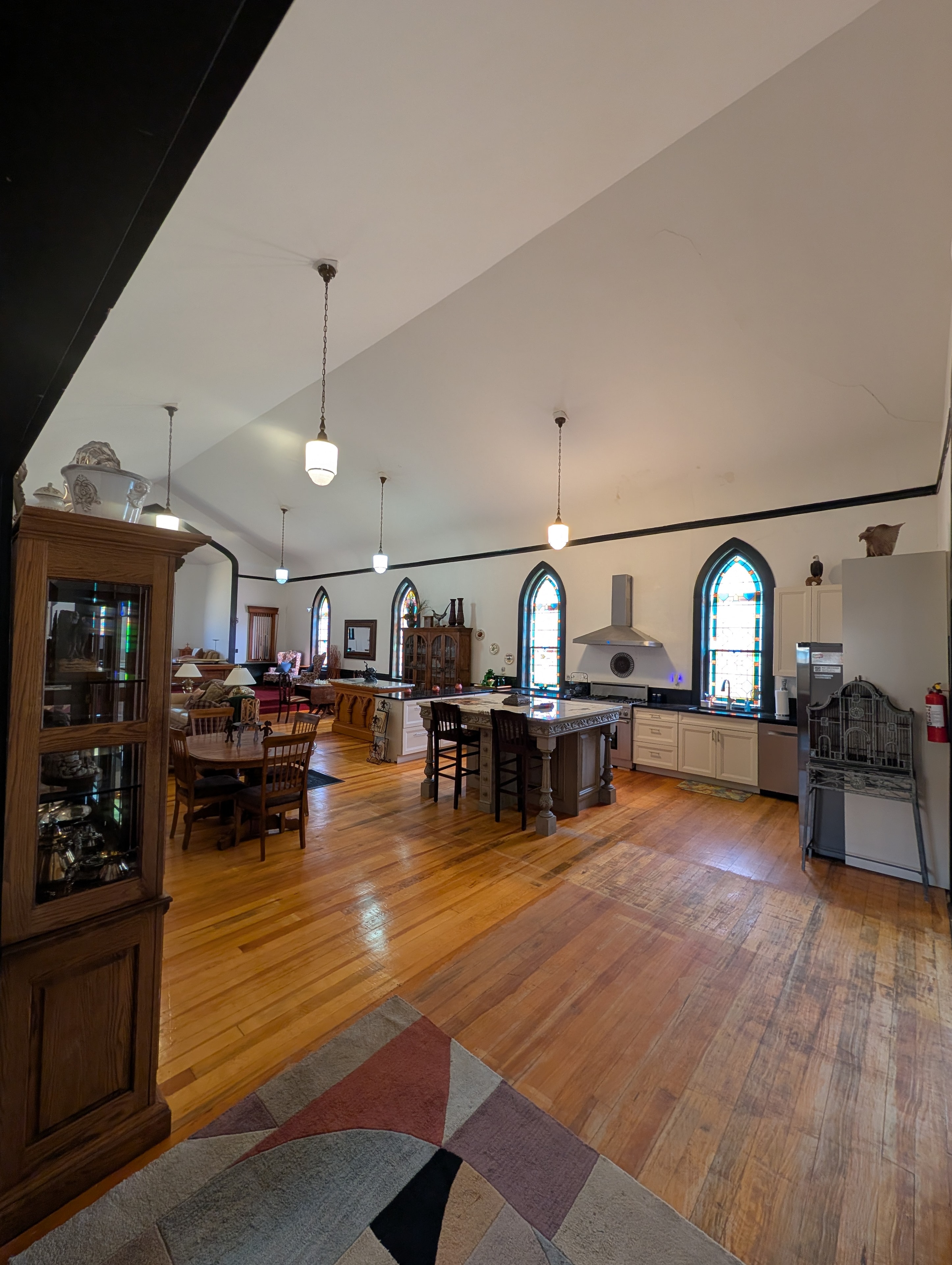 Entryway hallway with dark wood ceiling, tile floors, and framed artwork