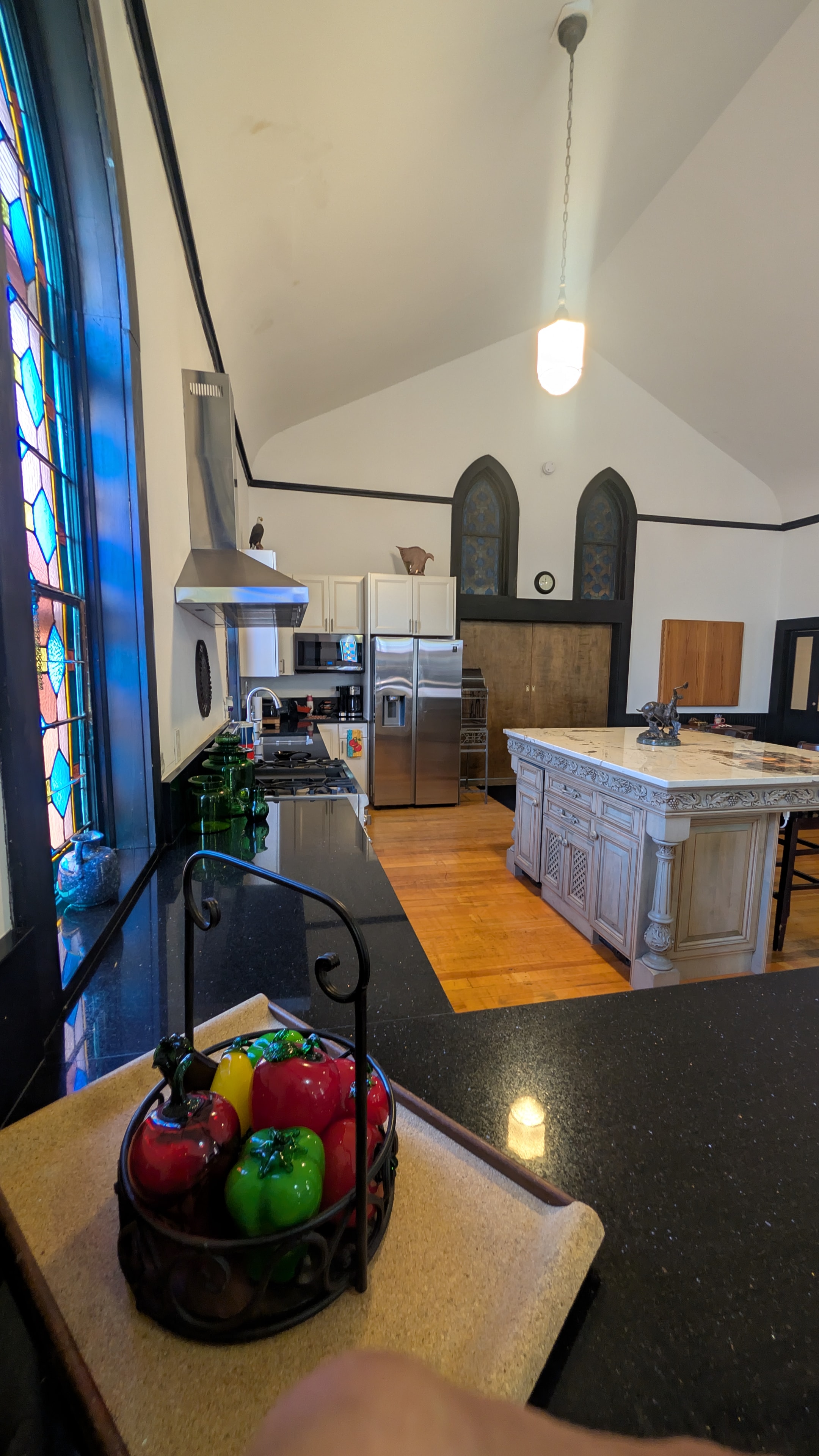 Chapel great room with pool table, stained glass windows, and open kitchen beyond