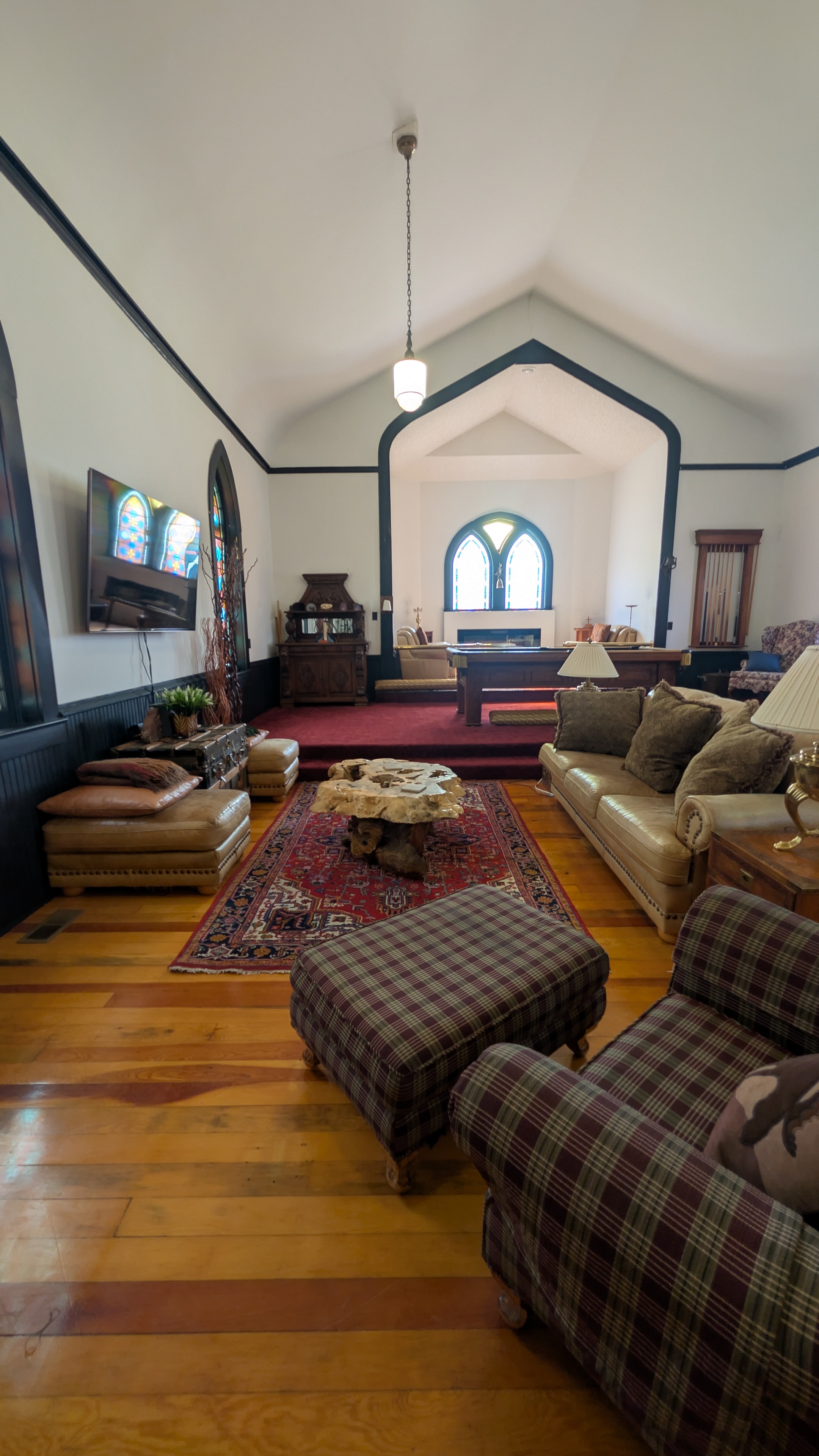 Kitchen and dining area with stained glass windows, marble island, and hardwood floors