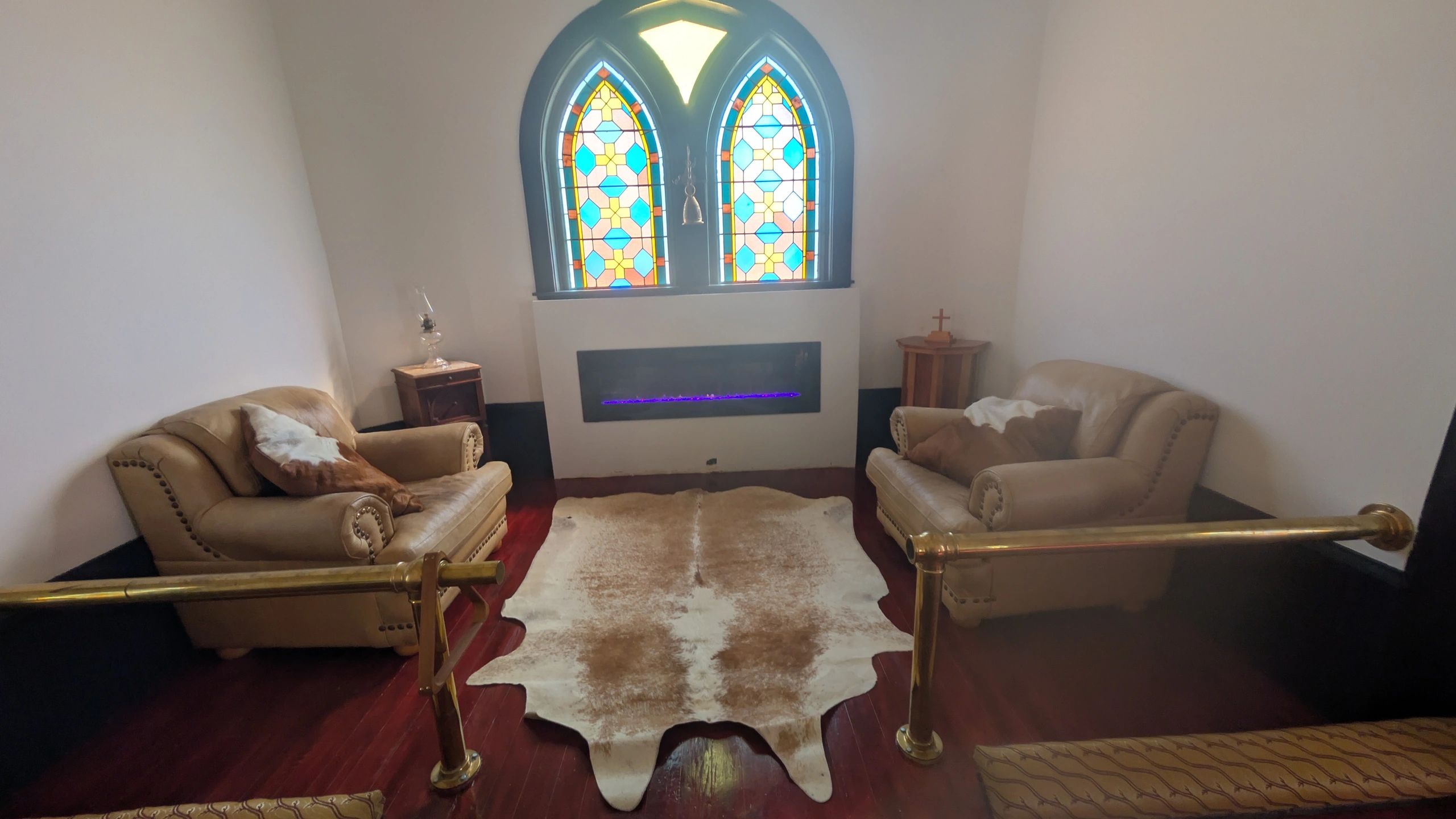 Chapel main gathering space with hardwood floors and vaulted ceiling