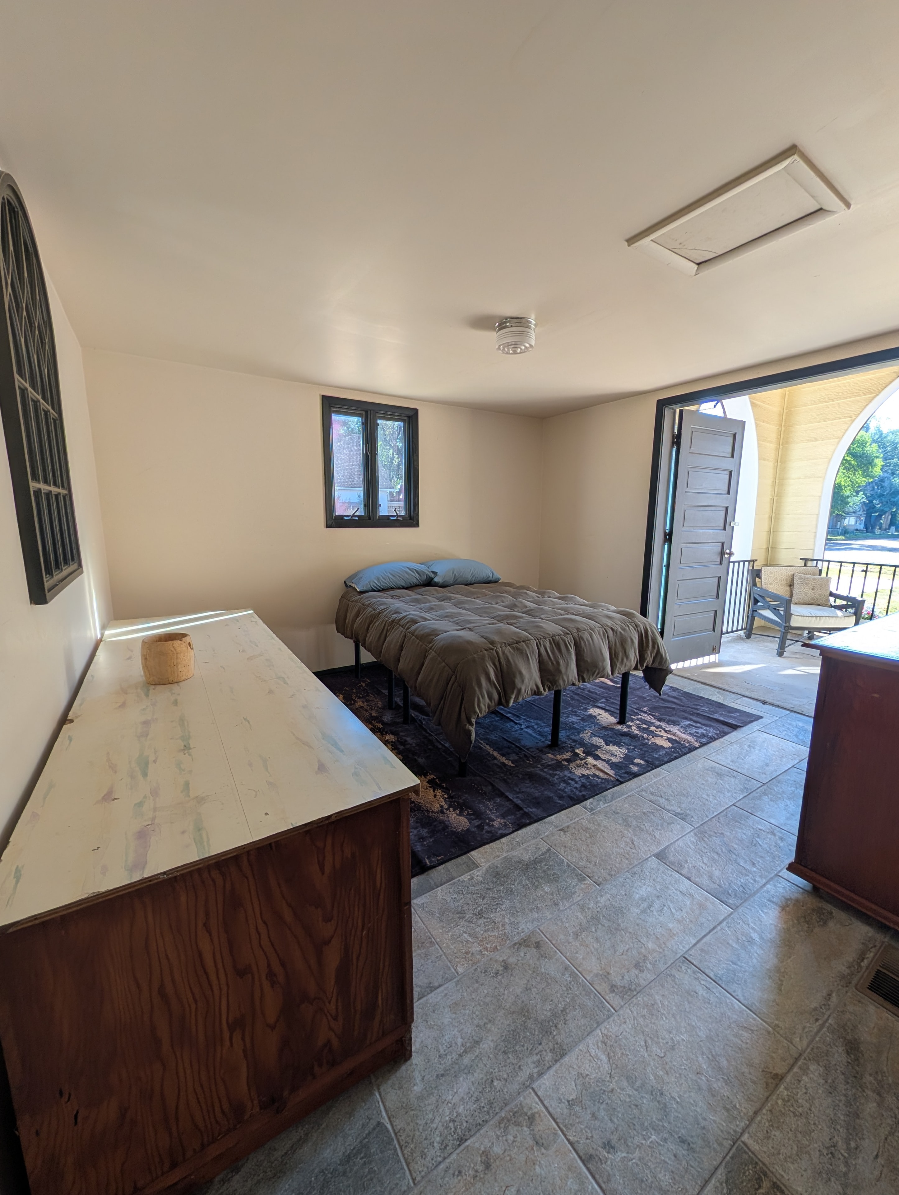 Bedroom with queen bed and private patio access